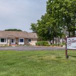 Photo of the exterior of the main office and Glenbrook Apartments sign
